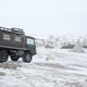 An all-terrain vehicle equipped with snow chains sits on the ridge known as Facebook Hill, so named because it’s one of the few spots in camp that gets cell reception.